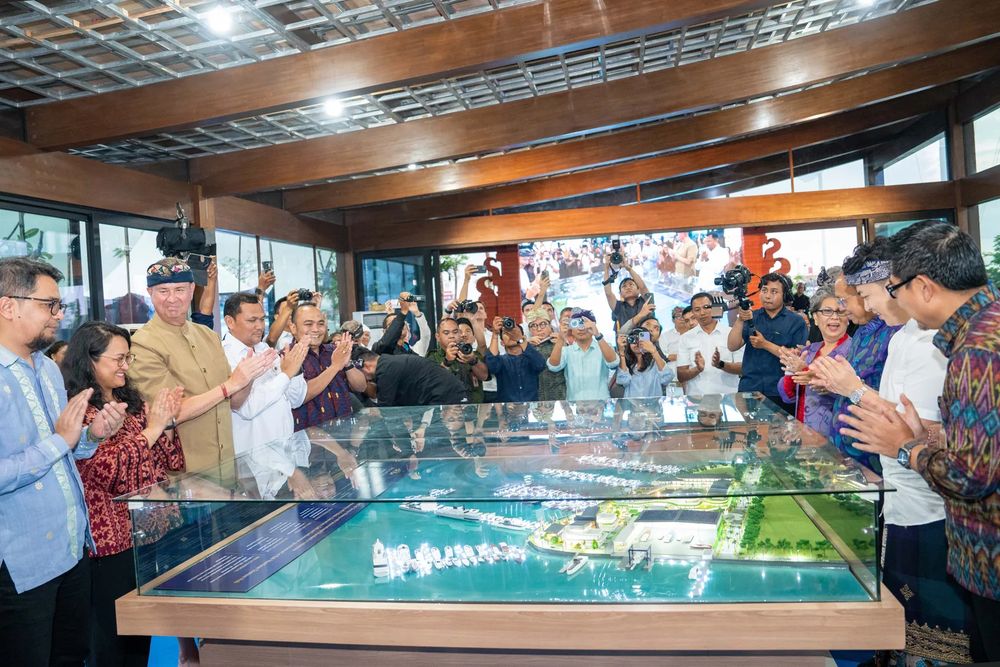 Guests viewing a scale model of the marina